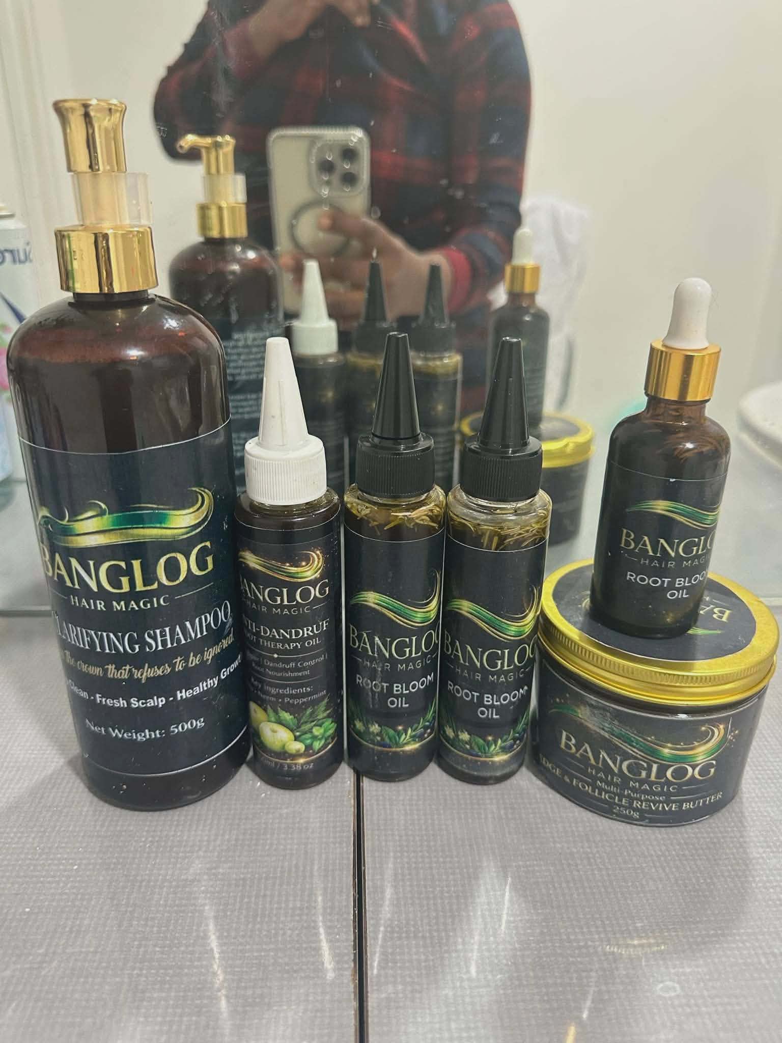 Full BANGLOG HAIR MAGIC product range — Root Bloom Oil, Clarifying Shampoo, Anti-Dandruff Oil, Edge and Follicle Revive Butter displayed together